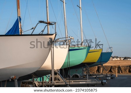 Close-up of pretty colorful sailboat hulls, at the dock