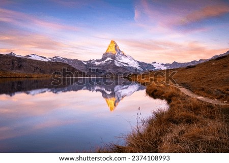 The famous Matterhorn reflected in the Stellisee during dawn. Zermatt, Switzerland Royalty-Free Stock Photo #2374108993