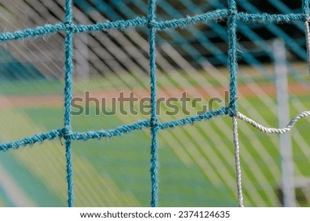 String net for a soccer goal.Sports football pitch - goal in construction details. Net with rectangular holes.
