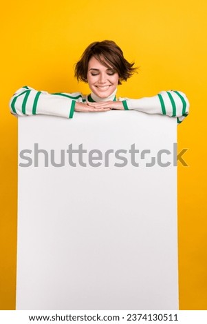 Vertical photo of nice young woman folded hands looking empty space banner cheap product discount isolated on yellow color background
