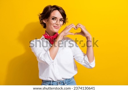 Photo of candid positive lady hands fingers show make heart symbol isolated on yellow color background
