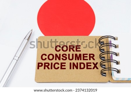 Economy and finance concept. On the flag of Japan lies a pen and a notebook with the inscription - core consumer price index. Royalty-Free Stock Photo #2374132019
