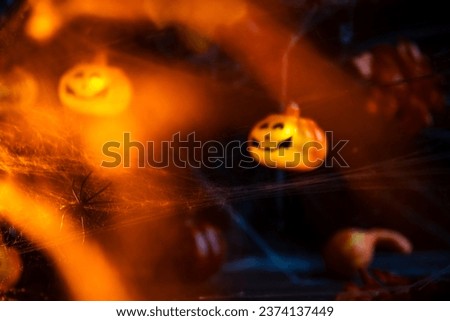 Halloween. spider crawls on the web. Garland with orange pumpkins