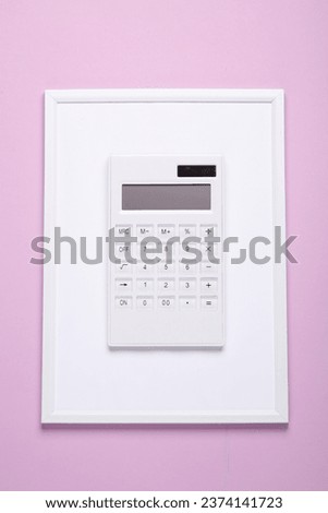 White calculator in frame on pastel background. Minimalism