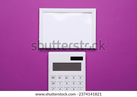Calculator with frame on purple background