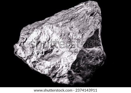 Raw manganese. Manganese stone isolated on black background. Mineral extraction of heavy metals. Royalty-Free Stock Photo #2374143911