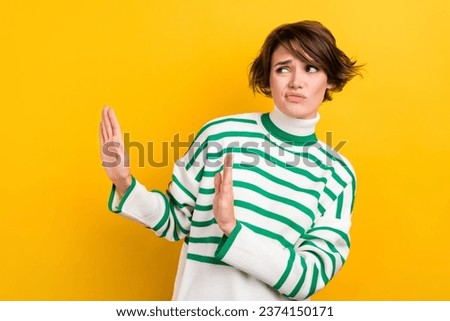 Photo of young girl skeptical suspicious look empty space dislike your proposition try drugs arms stop isolated on yellow color background