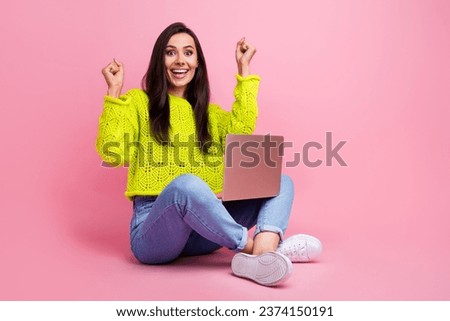 Photo of cheerful positive lady wear yellow trendy sweater use netbook rejoice autumn sale empty space isolated on pink color background