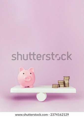 Close-up Of Balancing Stacked Of Coins Money and pink pig spear On on pink background. Balancing time and money