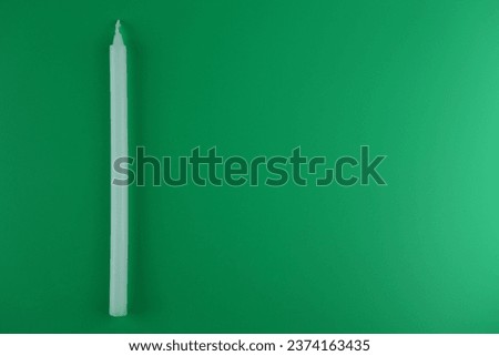 white thin candle on green screen used to light when no electricity or pay respect free empty area on the right for text