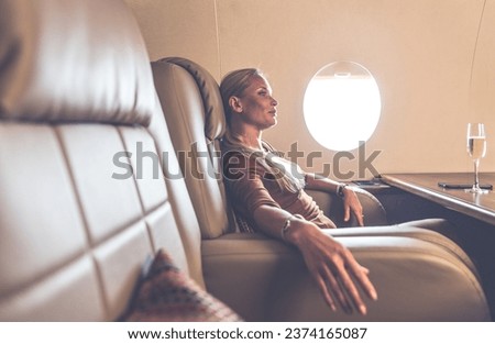 Beautiful woman traveling on her jet Royalty-Free Stock Photo #2374165087