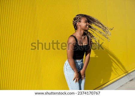  Portrait of young beautiful  woman posing on a yellow background