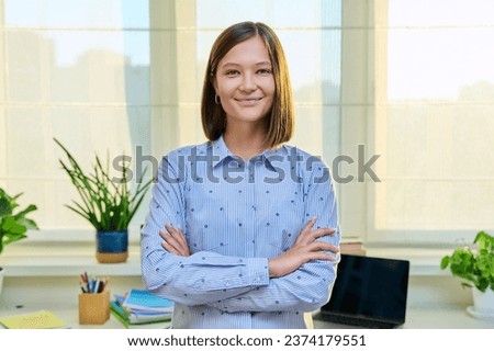 Portrait of smiling confident young woman, at home Royalty-Free Stock Photo #2374179551