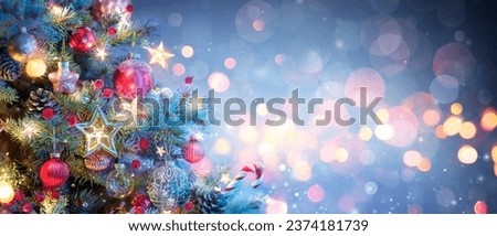 Christmas Tree With Ornaments In Blue - Baubles Hanging On Fir Branches With Glittering And Bokeh Lights In Abstract Defocused Background