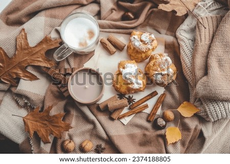Beautiful cozy autumn background top view, candle, sweets and coffee.