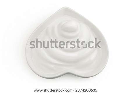 sour cream or yogurt in red ceramic bowl heart shaped isolated on white background with full depth of field. Top view. Flat lay