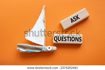 Ask Questions symbol. Wooden blocks with words Ask Questions. Beautiful orange background with boat. Business and Ask Questions concept. Copy space.
