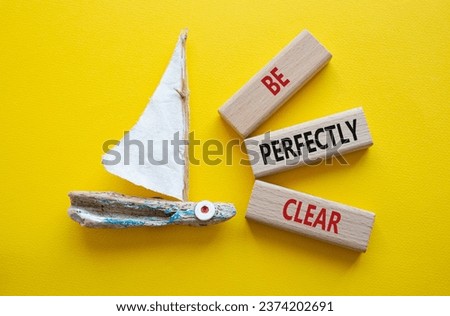 Be perfectly clear symbol. Concept words Be perfectlyclear on wooden blocks. Beautiful yellow background with boat. Business and Be perfectly clear concept. Copy space Royalty-Free Stock Photo #2374202691