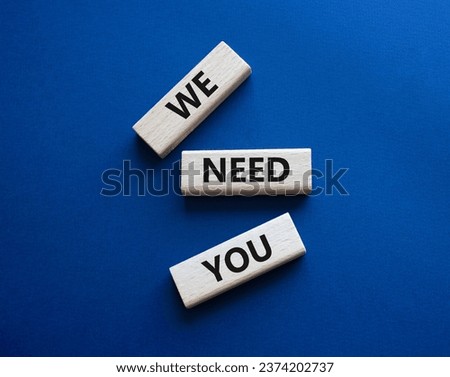 We need you symbol. Concept words We need you on wooden blocks. Beautiful deep blue background. Business and We need you concept. Copy space.