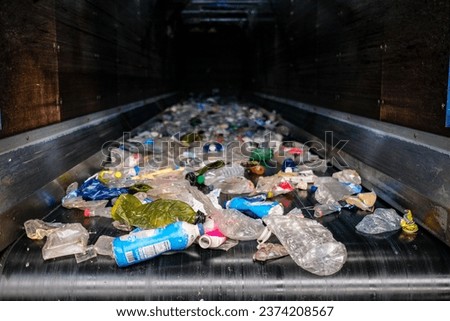 Conveyor belt for plastic containers for recycling Royalty-Free Stock Photo #2374208567