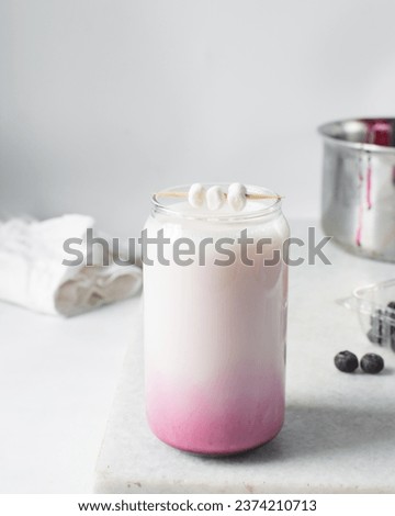 Pink  milkshake in a can shaped glass, blueberry latte in a glass shaped like a can, Aesthetic cafe ombre drink in a can glass