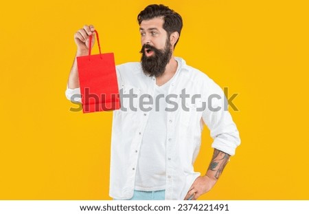 shopping man in yellow studio, copy space. shopping man on background.