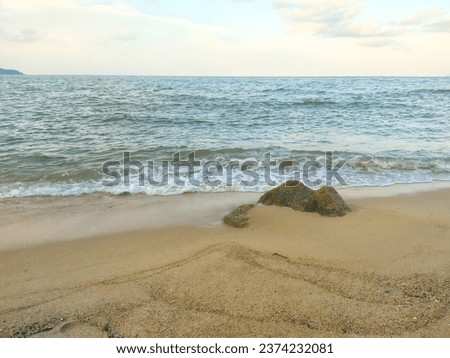 View of small waves and rocks on the beach of Teluk Lipat, Dungun.