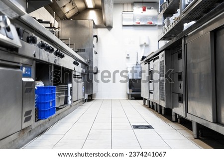 Corridor of a restaurant kitchen with all its metal cabinets on the sides