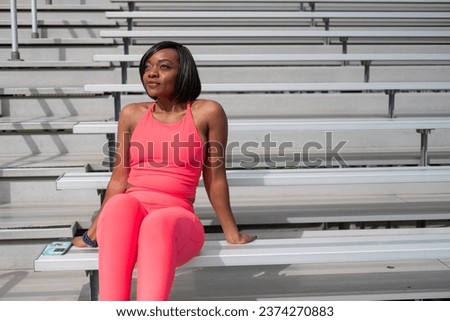 Black African American woman exercising outdoors with bright color clothing