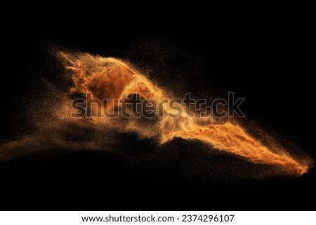Dry river sand explosion.Brown color sand splash against black background. Royalty-Free Stock Photo #2374296107