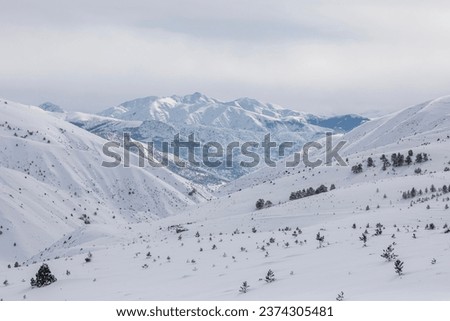 winter landscape with snowy mountains and trees Royalty-Free Stock Photo #2374305481