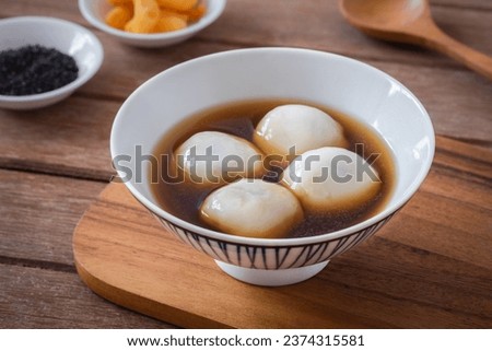 Glutinous rice balls filled with black sesame in sweet ginger soup Royalty-Free Stock Photo #2374315581