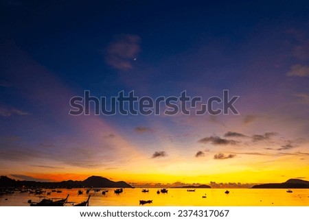 Amazing sunset or sunrise sky over sea landscape,Beautiful colorful light of nature with boats in the sea,Majestic nature view seascape