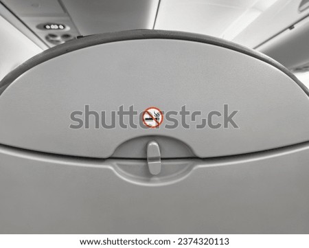 No smoking sign sticker on airplane seat, chair back