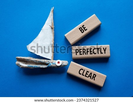 Be perfectly clear symbol. Concept words Be perfectlyclear on wooden blocks. Beautiful blue background with boat. Business and Be perfectly clear concept. Copy space Royalty-Free Stock Photo #2374321527
