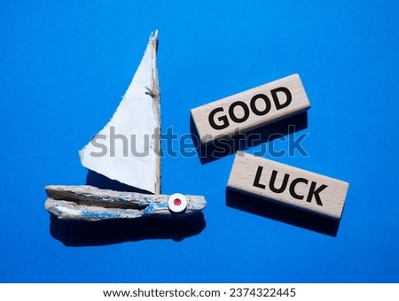 Good luck symbol. Wooden blocks with words Good luck. Beautiful blue background with boat. Business and Good luck concept. Copy space.
