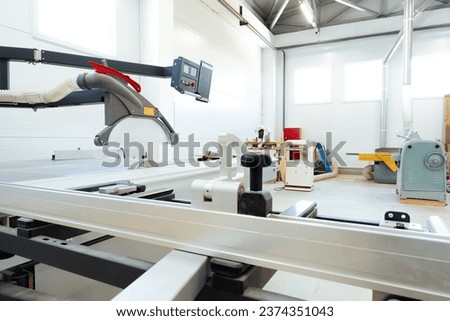 Woodworking equipment in a furniture manufacture workshop Royalty-Free Stock Photo #2374351043