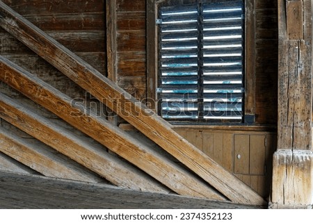 Window with shutters of covered wooden bridge at the old town of Swiss City of Baden on a sunny summer day. Photo taken August 19th, 2023, Baden, Switzerland.