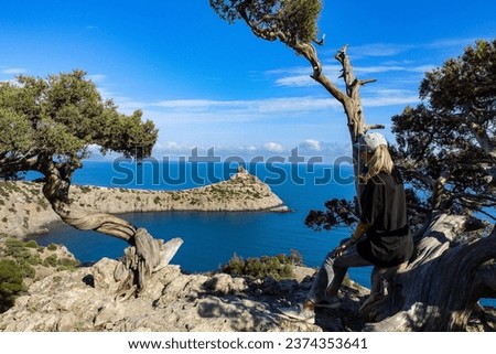 A girl on the background of a panorama of Cape Kapchik on the Galitsin trail. Black Sea Russia.