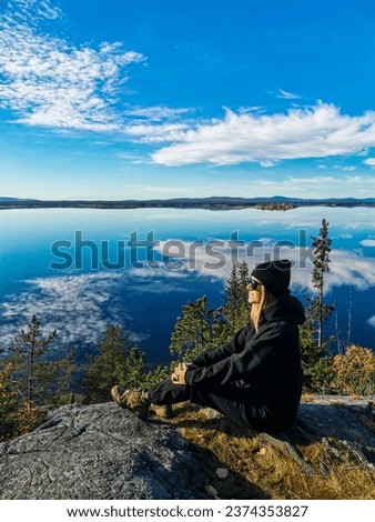 A girl on the White Sea coast on a sunny day. Karelia. Russia. 2021