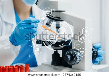 DNA molecule testing concepts. The doctor in a mask examines DNA molecules on the chemical laboratory with virtual icon screen