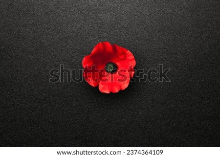 Poppy flower on black textured background. Decorative flower for Remembrance Day. Memorial Day. Veterans day. Royalty-Free Stock Photo #2374364109