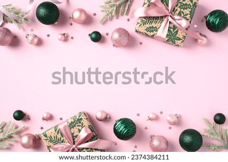 Christmas frame of elegant gift boxes, stylish Xmas balls ornaments, fir tree branches, confetti on light pink background. Flat lay, top view, copy space.
