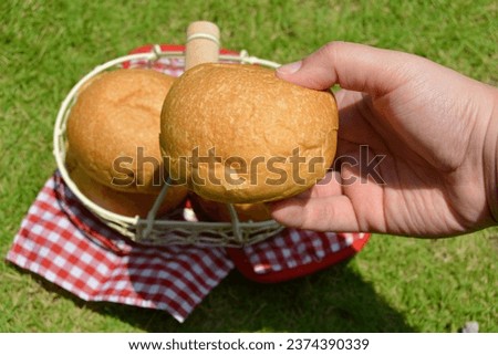 A Basket Of Bread And Handkerchief On Grass