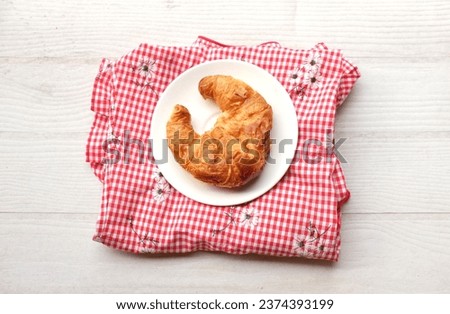 tasty Fresh crispy croissants arranged in white plate on cloth  . Flat lay composition food photography.
Morning French breakfast with fresh pastries.