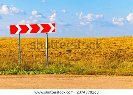 road sign indicating a sharp right turn. warning road sign on a country road