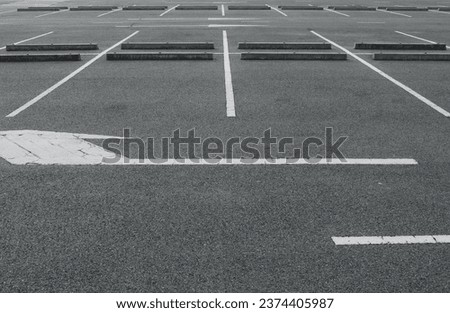 Empty parking lot with traffic white arrow background.