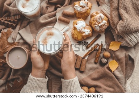 Cup of coffee in hands, cozy autumn.