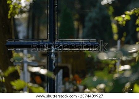 CEMETERY - An steel crucifix with a figurine of Jesus on grave