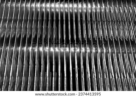 Close-up View of an AC Evaporator Coil with a Grid Radiator Pattern Royalty-Free Stock Photo #2374413595